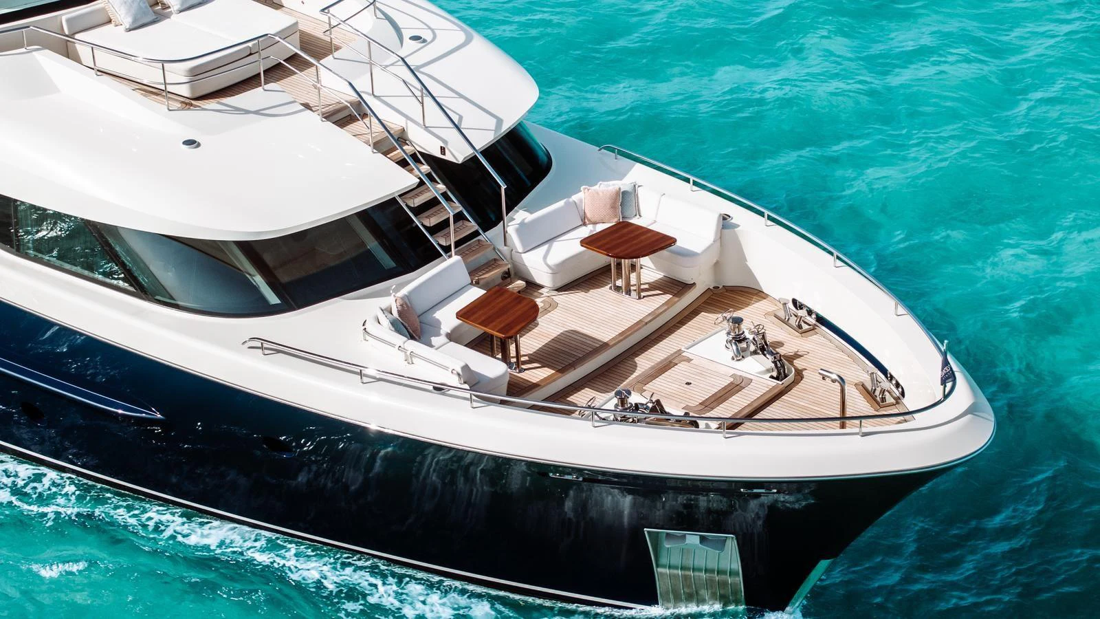 The yacht's foredeck features elegant seating and tables, perfect for enjoying the open sea. aboard MIDNIGHT SAGA Yacht for Sale