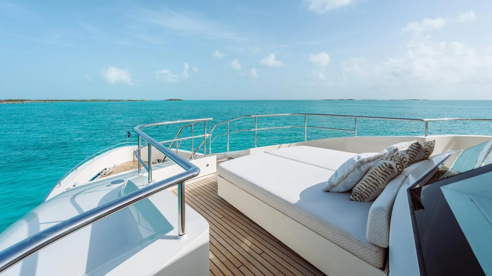 The yacht's foredeck features a luxurious sunbed with stunning ocean views. aboard MIDNIGHT SAGA Yacht for Sale