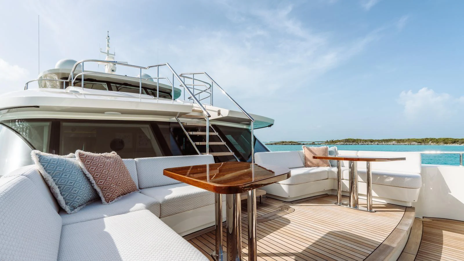 The aft deck features comfortable seating with elegant wooden tables, perfect for enjoying the ocean views. aboard MIDNIGHT SAGA Yacht for Sale
