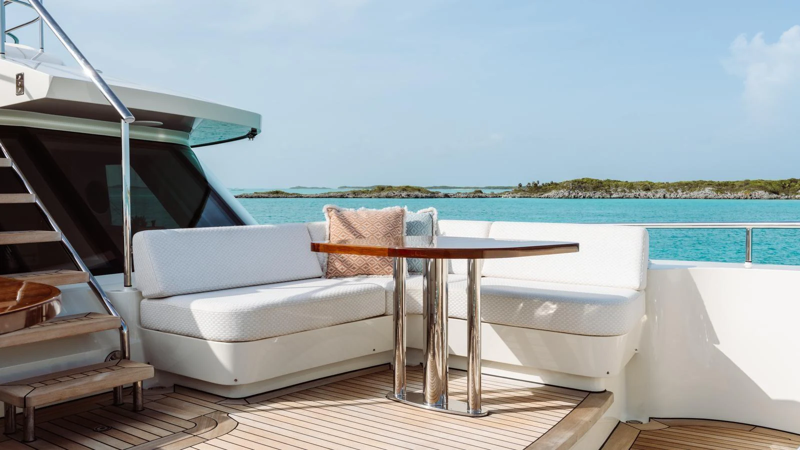 The aft deck features a comfortable seating area with a stylish table, perfect for enjoying the scenic views. aboard MIDNIGHT SAGA Yacht for Sale