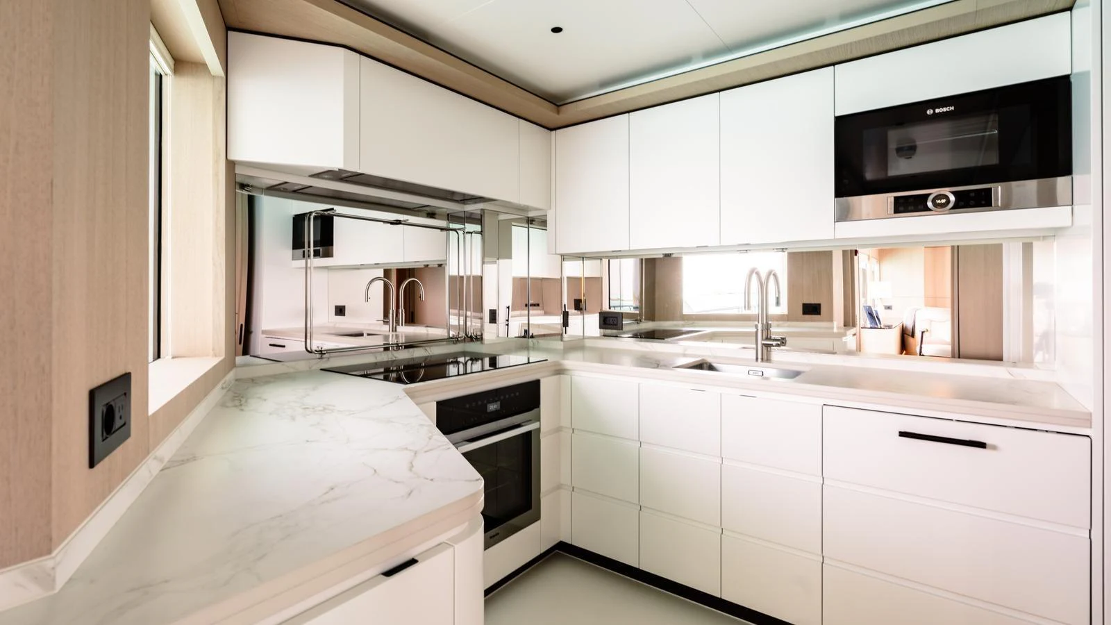 The yacht's galley features modern appliances and sleek, minimalist design. aboard MIDNIGHT SAGA Yacht for Sale
