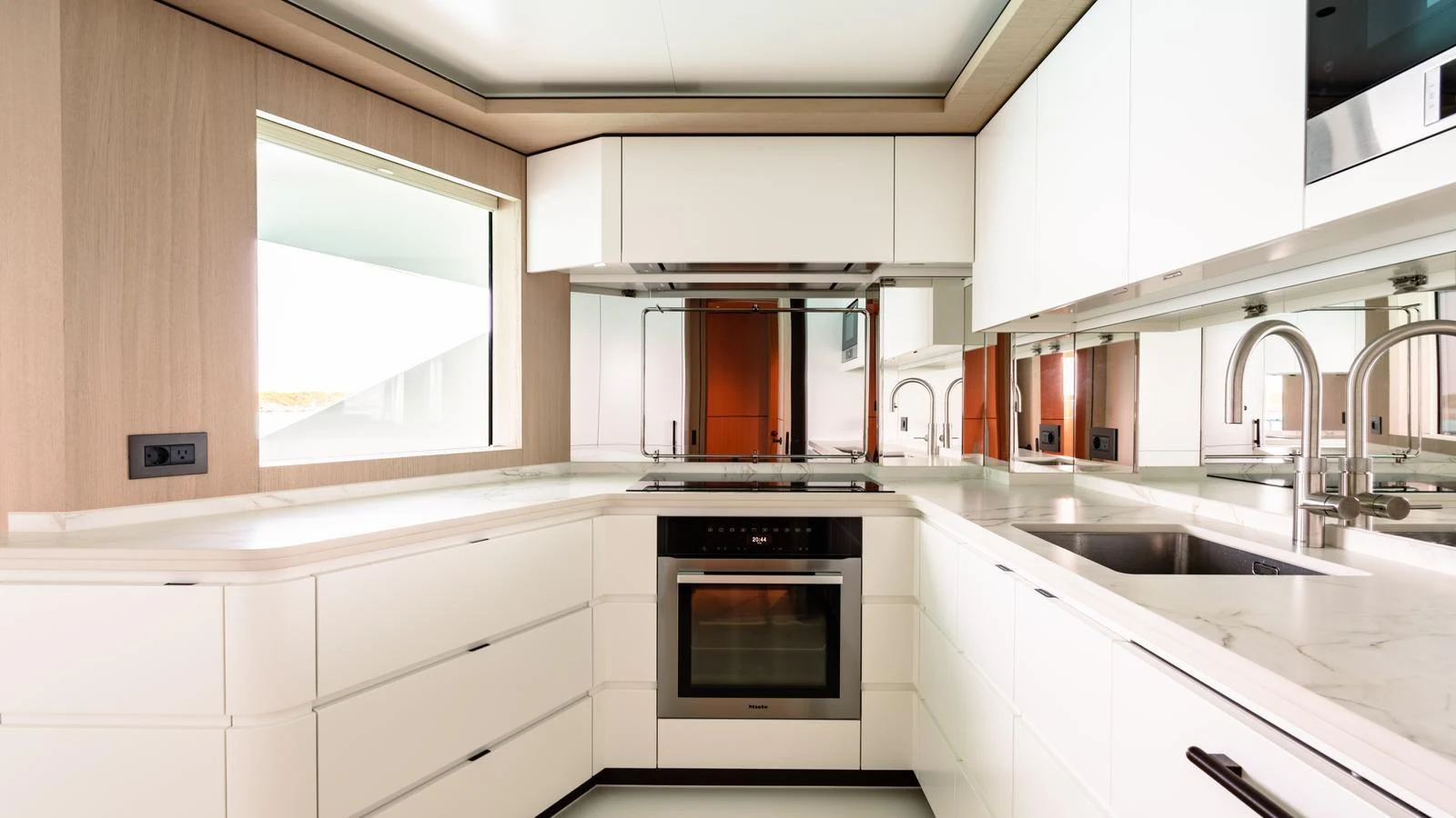 The yacht's galley features modern appliances and sleek white cabinetry, creating a bright and functional space. aboard MIDNIGHT SAGA Yacht for Sale
