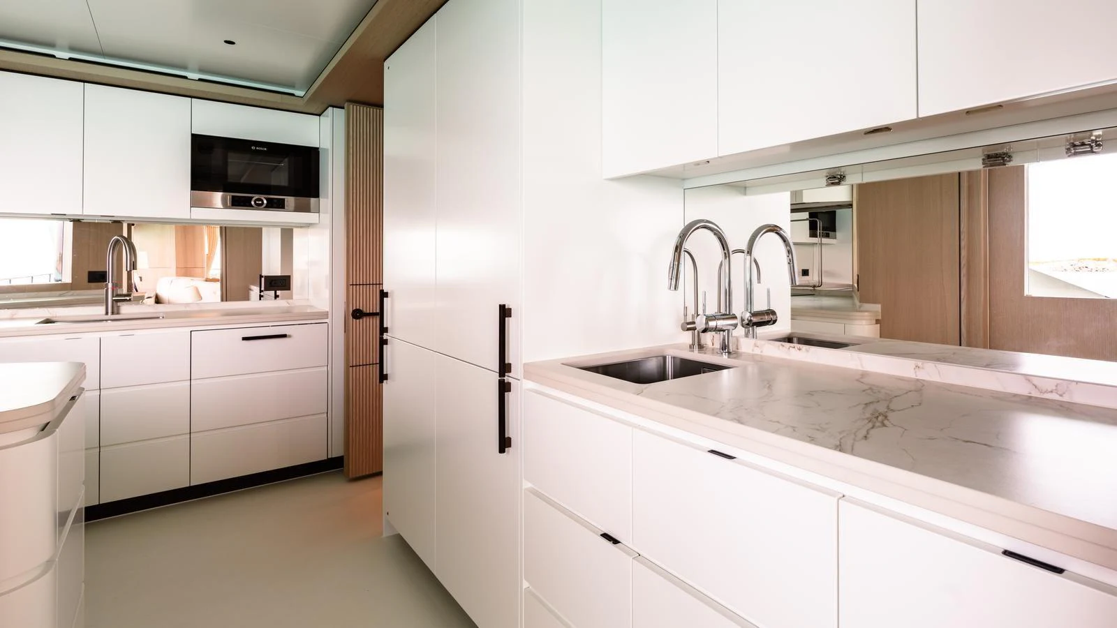 The yacht's galley features sleek, modern cabinetry and high-end appliances. aboard MIDNIGHT SAGA Yacht for Sale
