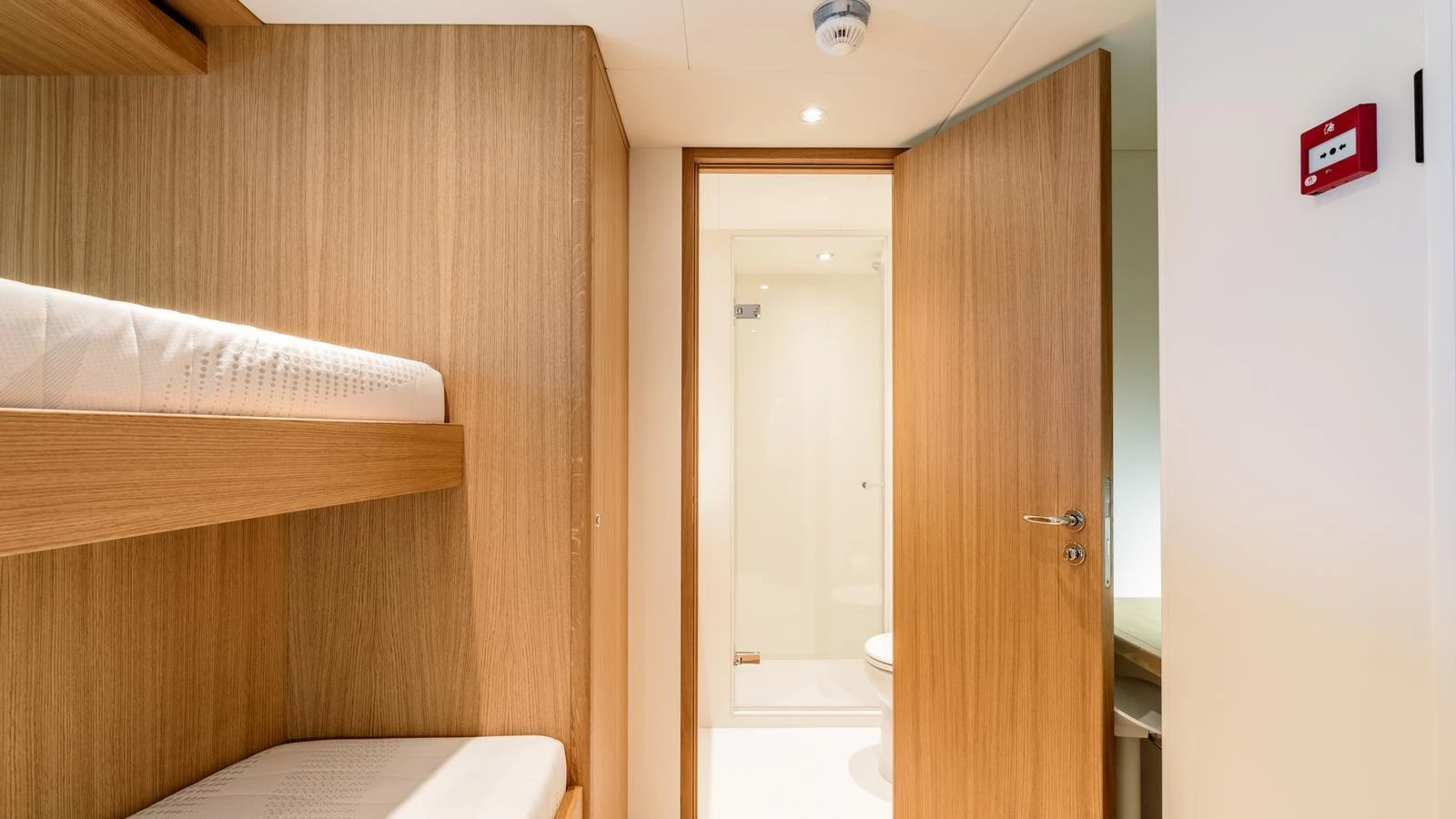 A cozy cabin featuring bunk beds and a private bathroom. aboard MIDNIGHT SAGA Yacht for Sale