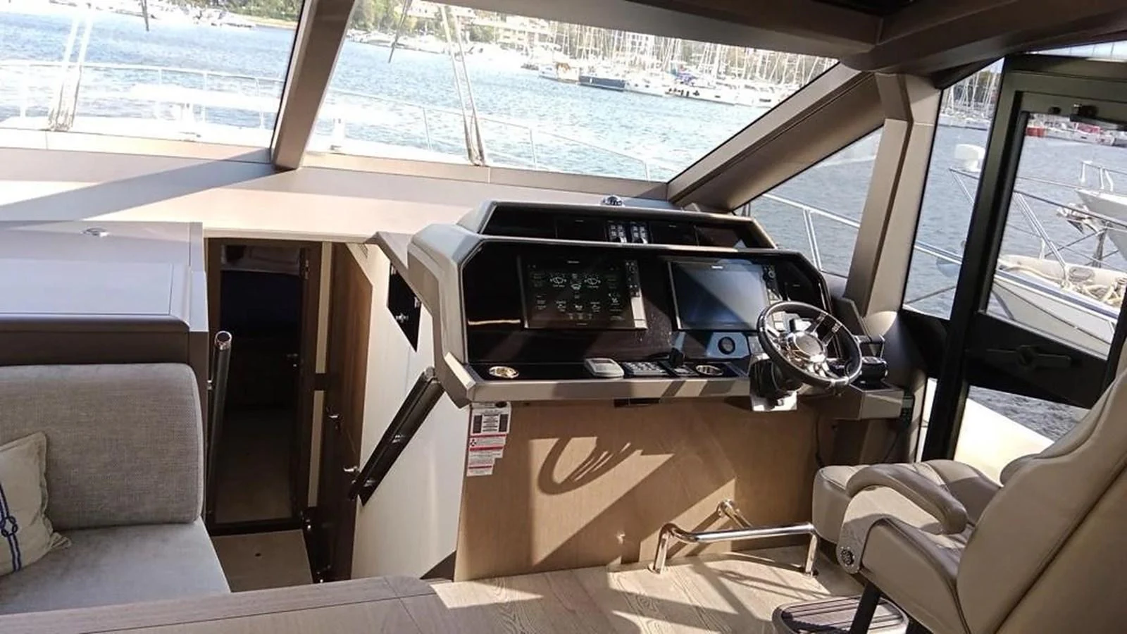 The helm station offers a commanding view with state-of-the-art navigation equipment and luxurious seating. aboard VIRTUS Yacht for Sale