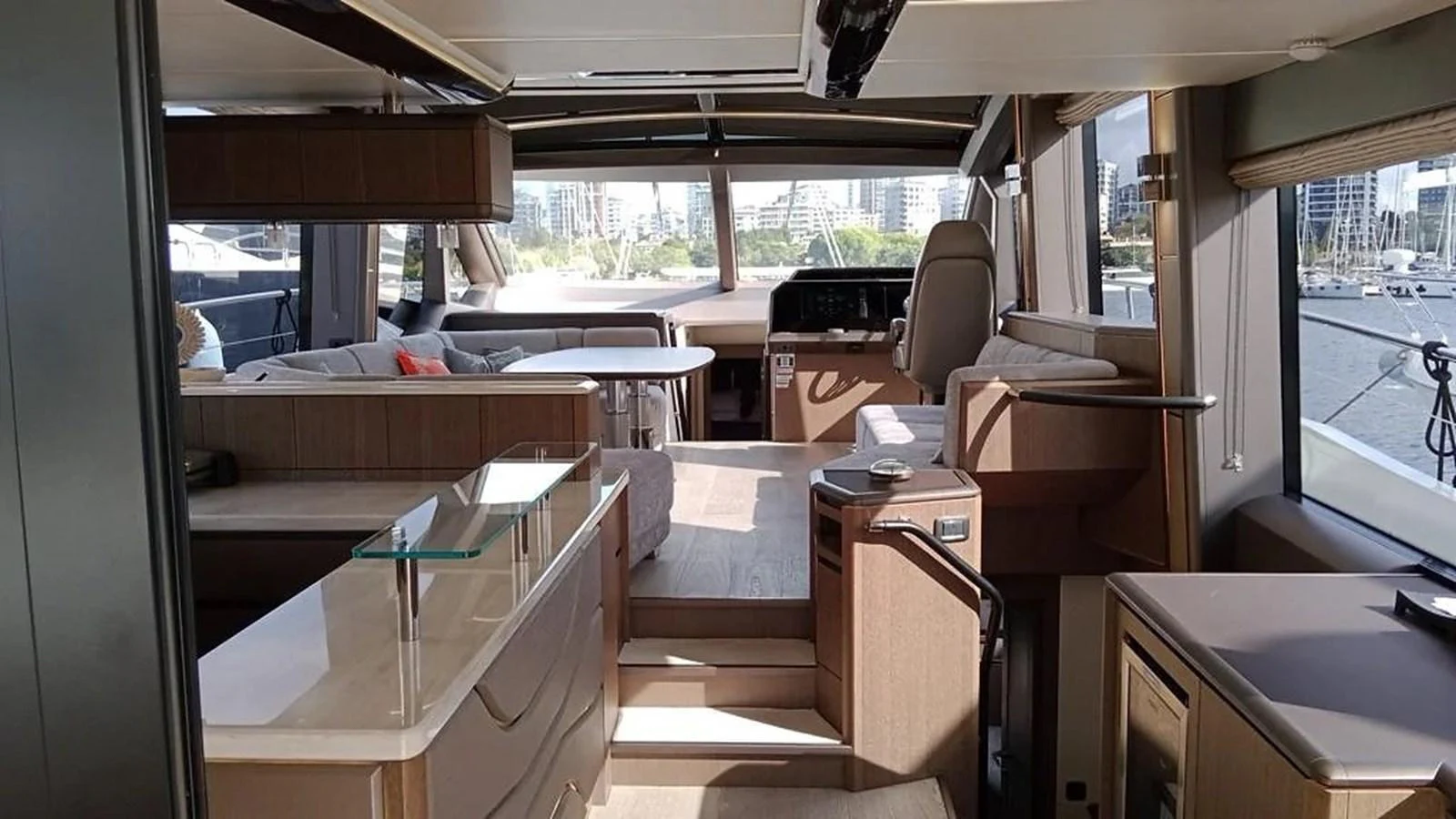 The yacht's salon features modern furnishings and large windows offering a panoramic view. aboard VIRTUS Yacht for Sale