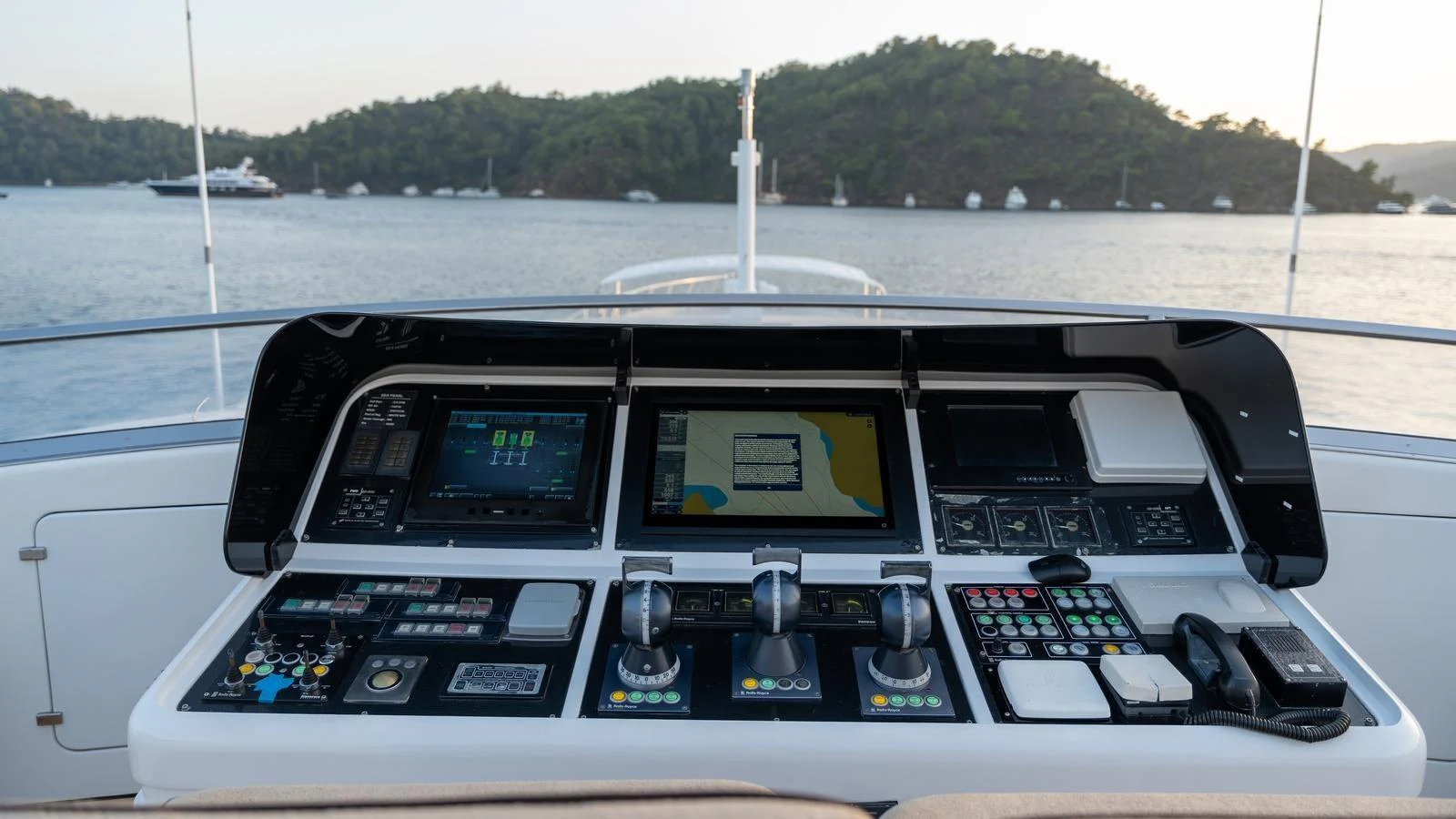 The helm station features advanced navigation and control systems with a scenic view of the surrounding waters. aboard SEA PEARL Yacht for Sale