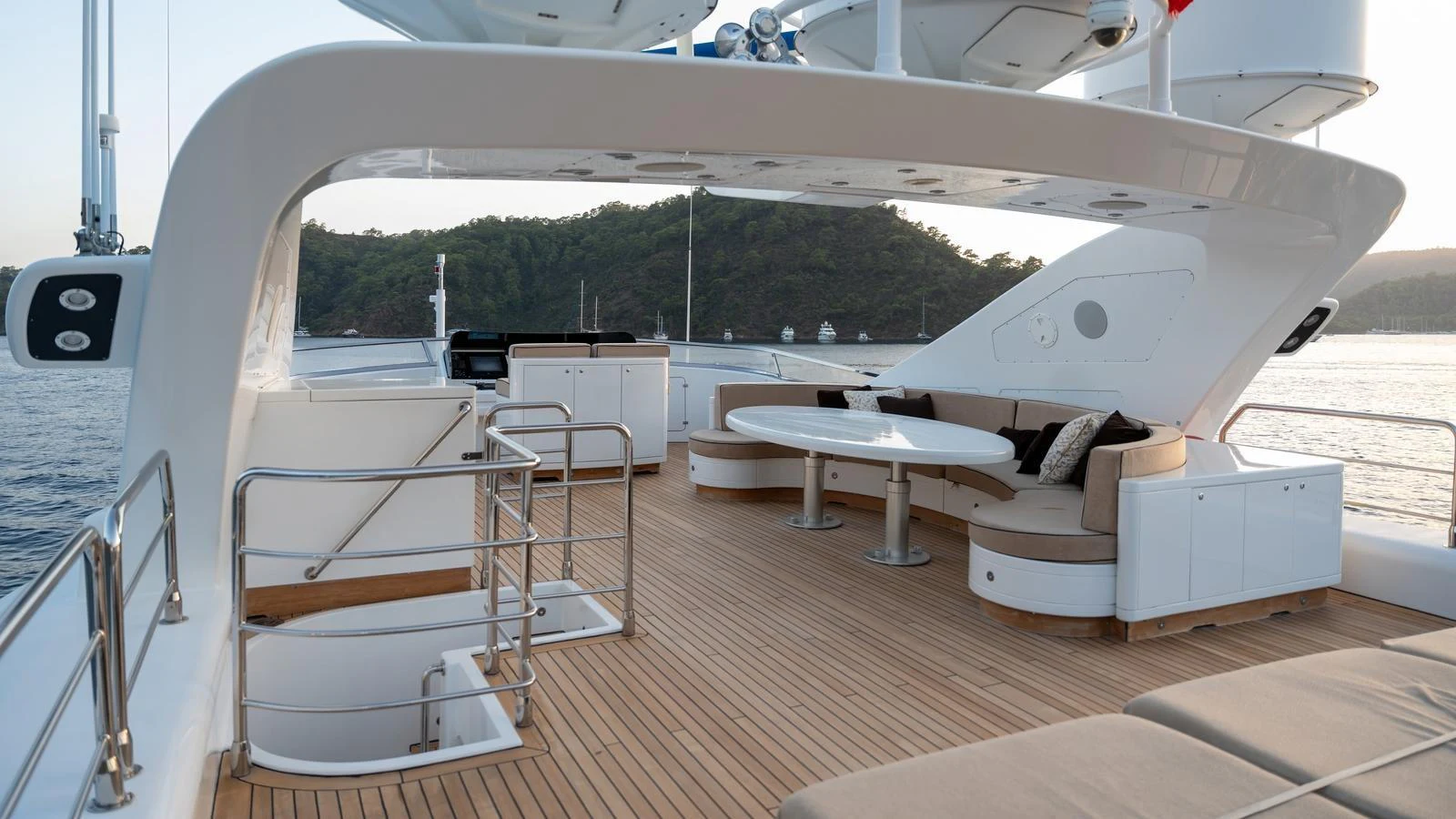 The aft deck features a spacious seating area with a large table, perfect for outdoor relaxation and dining. aboard SEA PEARL Yacht for Sale