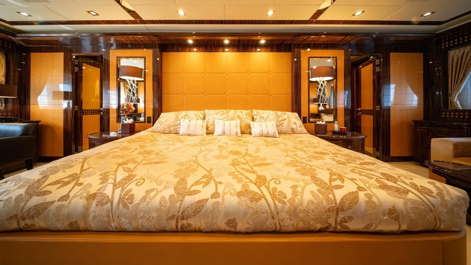 The master stateroom features a luxurious king-sized bed with elegant bedding and warm lighting. aboard SEA PEARL Yacht for Sale