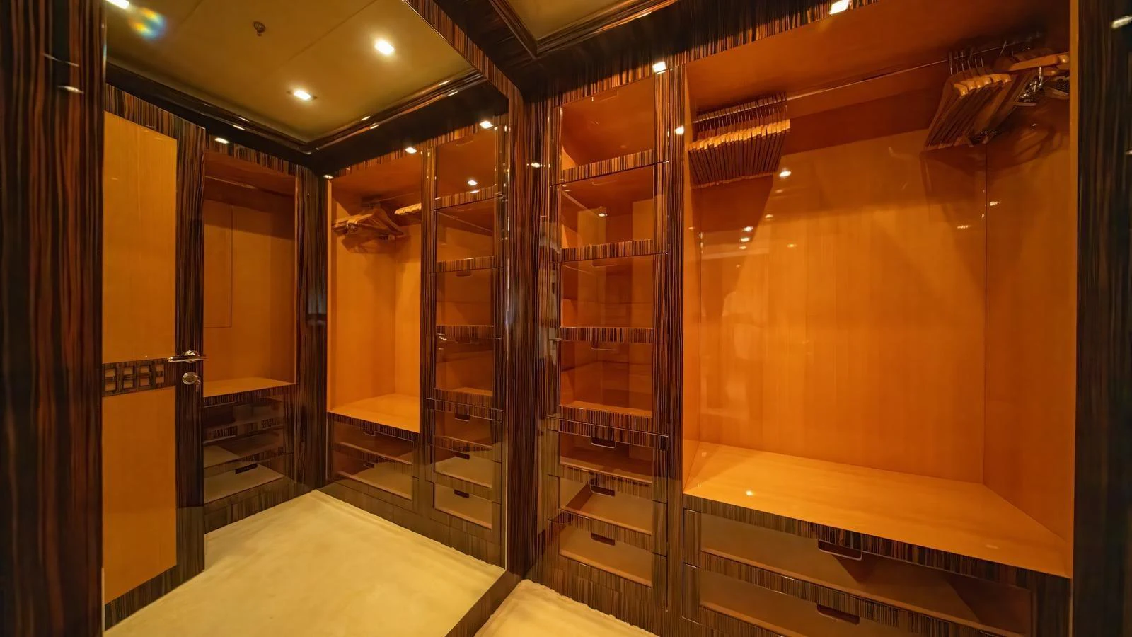 A luxurious walk-in closet with ample shelving and elegant wood finishes. aboard SEA PEARL Yacht for Sale