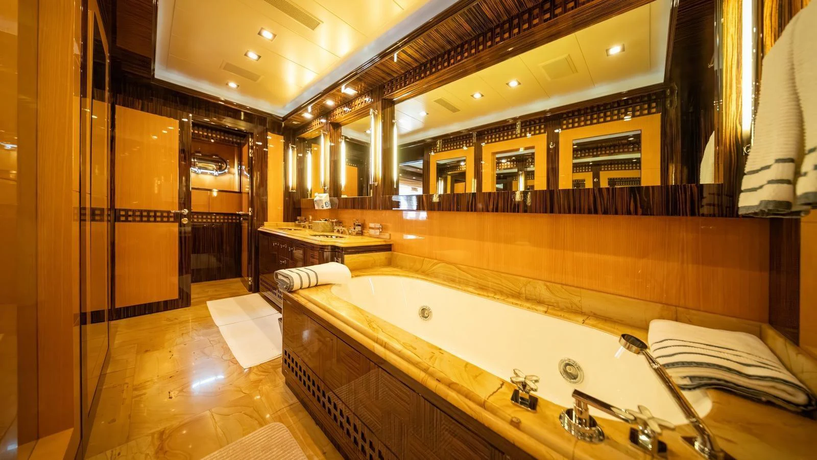 The luxurious bathroom features a spacious bathtub and elegant wood accents. aboard SEA PEARL Yacht for Sale