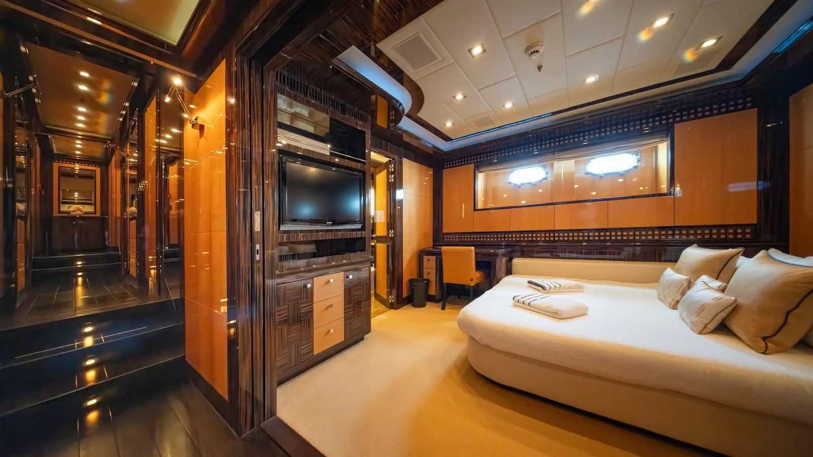 The master stateroom features luxurious wood paneling, a large bed, and modern amenities for ultimate comfort. aboard SEA PEARL Yacht for Sale