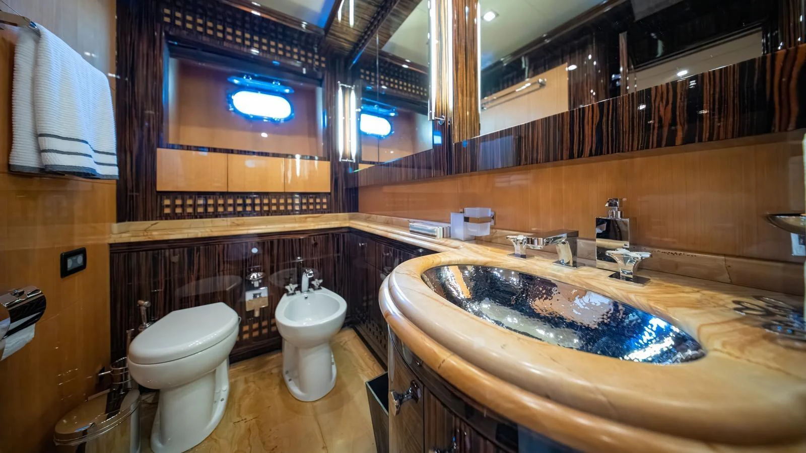 The yacht's bathroom features luxurious fixtures and elegant wood accents. aboard SEA PEARL Yacht for Sale