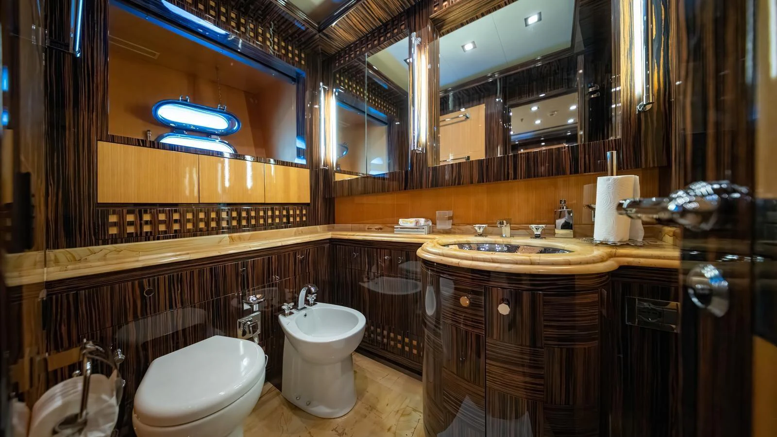 The yacht's bathroom features luxurious wood paneling and modern fixtures. aboard SEA PEARL Yacht for Sale