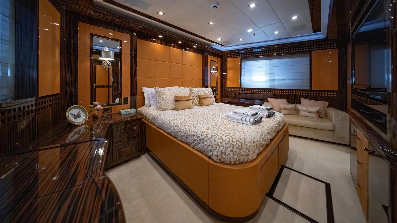 The master stateroom features luxurious bedding and elegant wood finishes, creating a warm and inviting atmosphere. aboard SEA PEARL Yacht for Sale