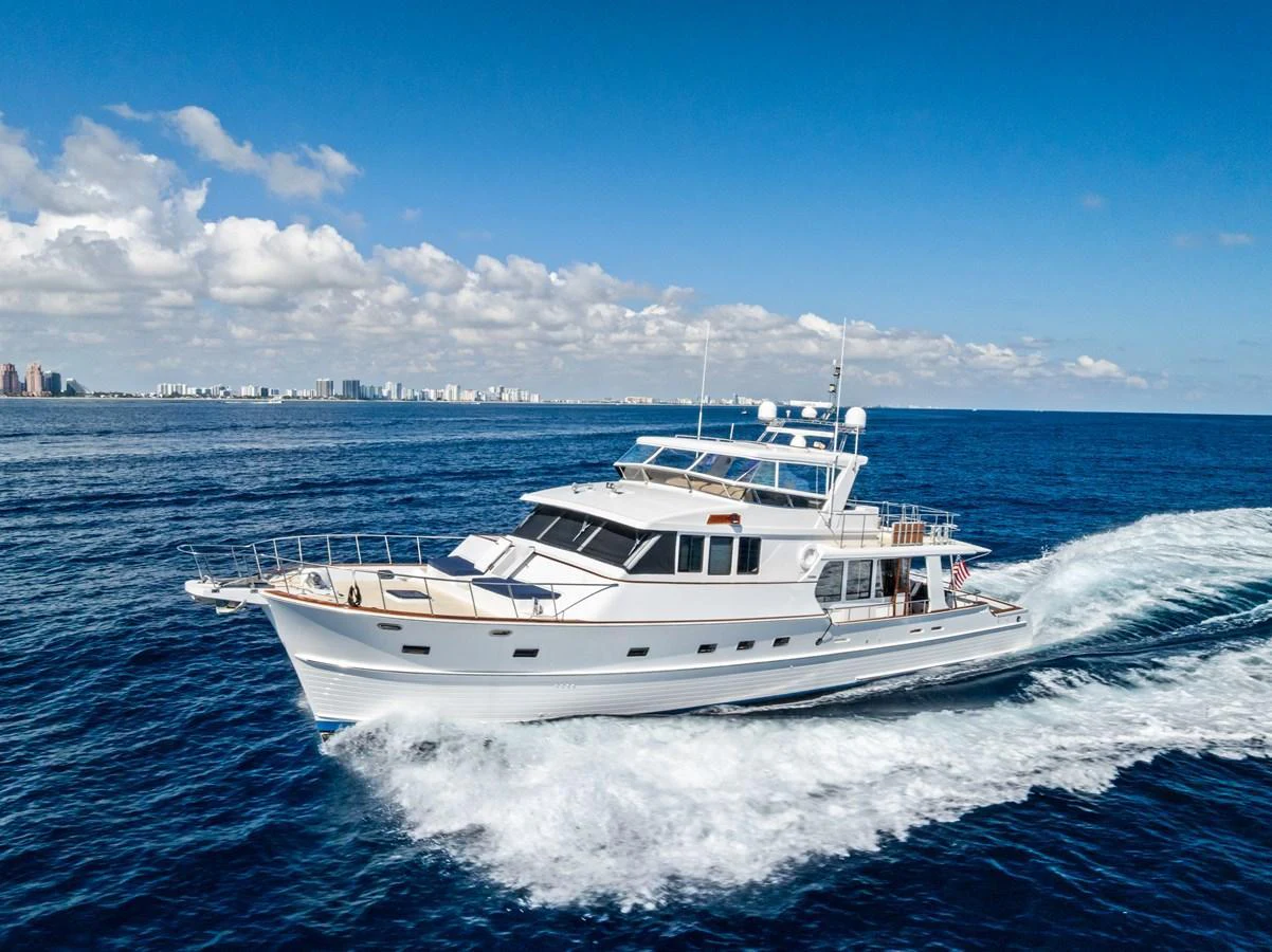 A classic yacht cruises gracefully on the open sea under a clear blue sky. aboard EL LEGADO Yacht for Sale