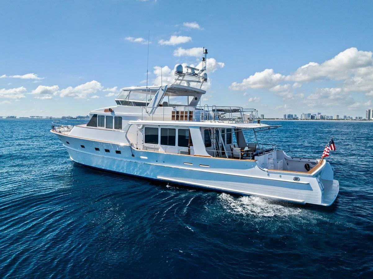 A stunning yacht cruising on calm blue waters under a clear sky. aboard EL LEGADO Yacht for Sale