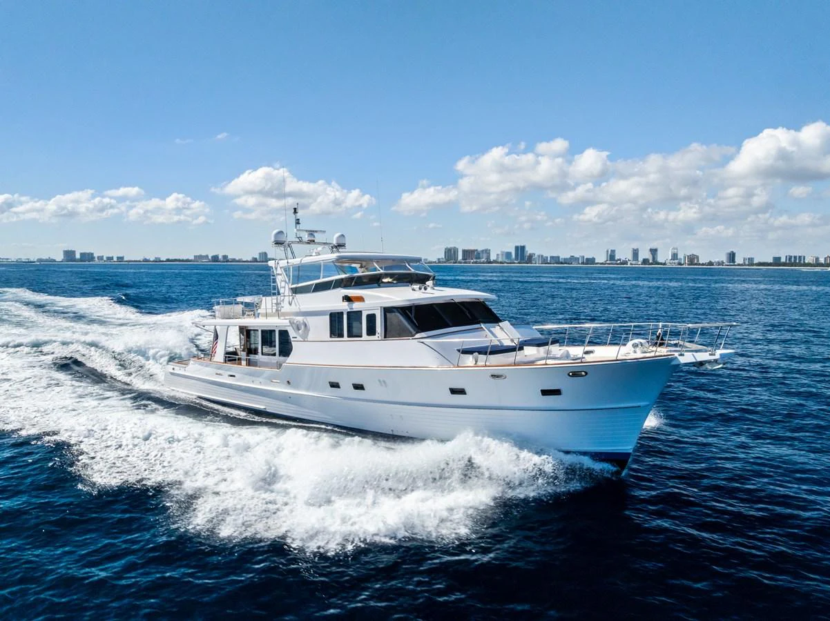 A sleek yacht cruising through the open water on a sunny day. aboard EL LEGADO Yacht for Sale