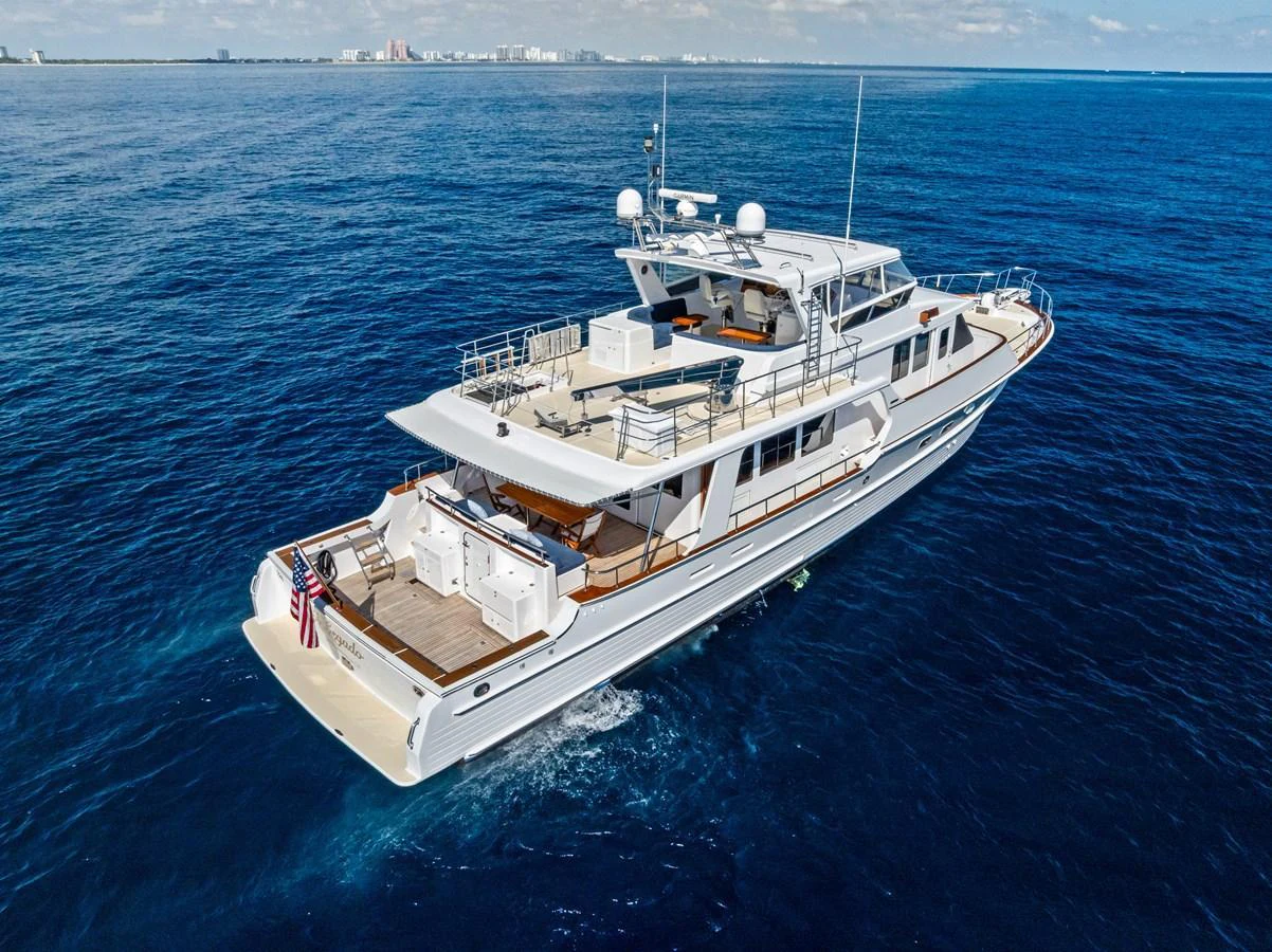 A sleek yacht cruises through the open ocean, showcasing its spacious decks and modern design. aboard EL LEGADO Yacht for Sale