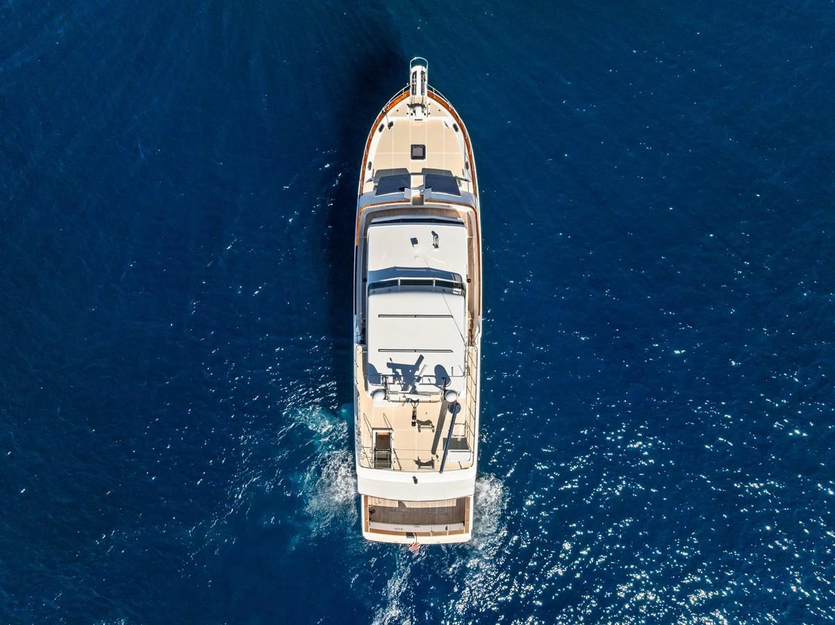 Aerial view of a yacht cruising through deep blue waters. aboard EL LEGADO Yacht for Sale