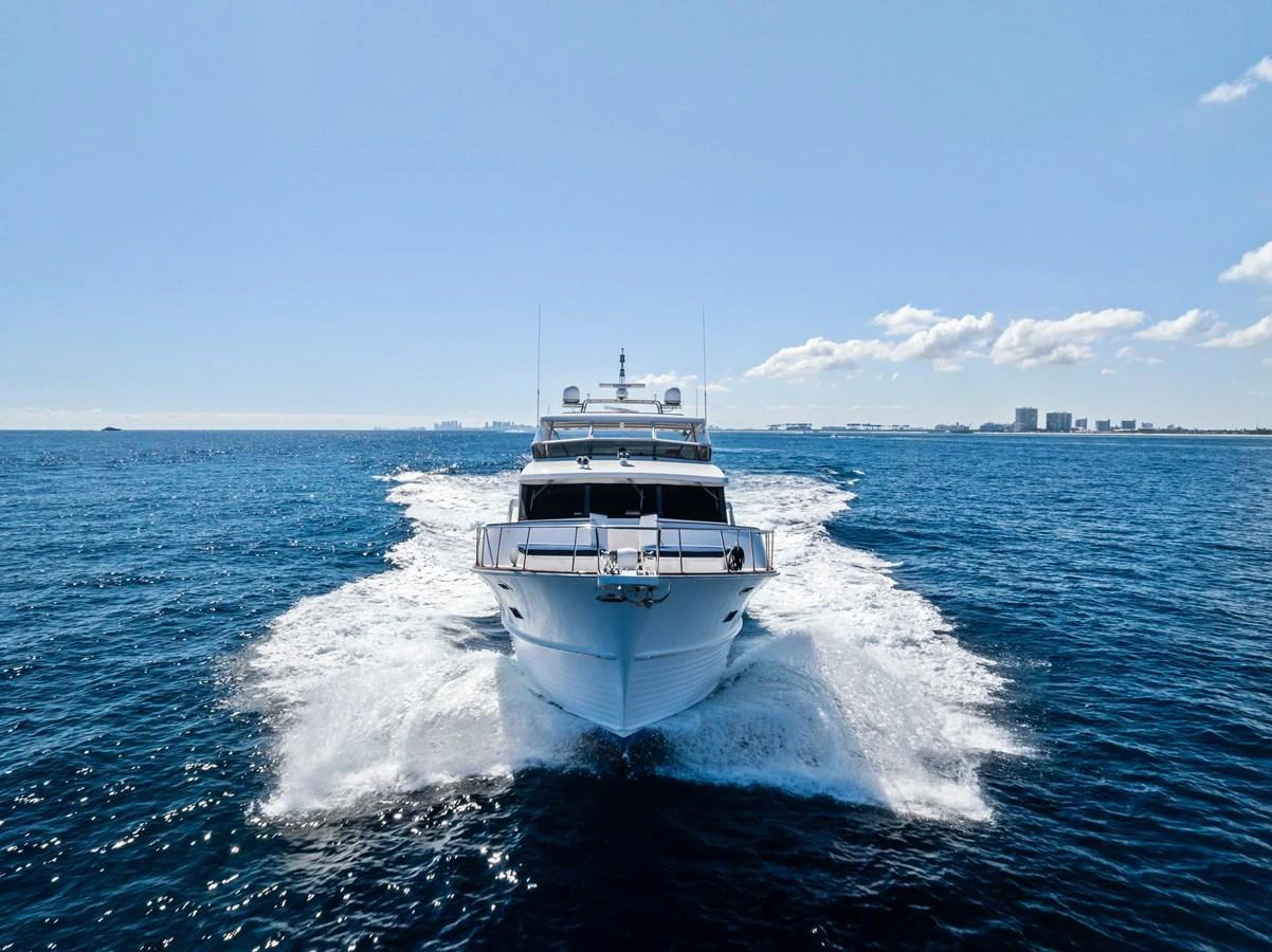 A stunning yacht cruises through the open water, creating a beautiful wake behind it. aboard EL LEGADO Yacht for Sale