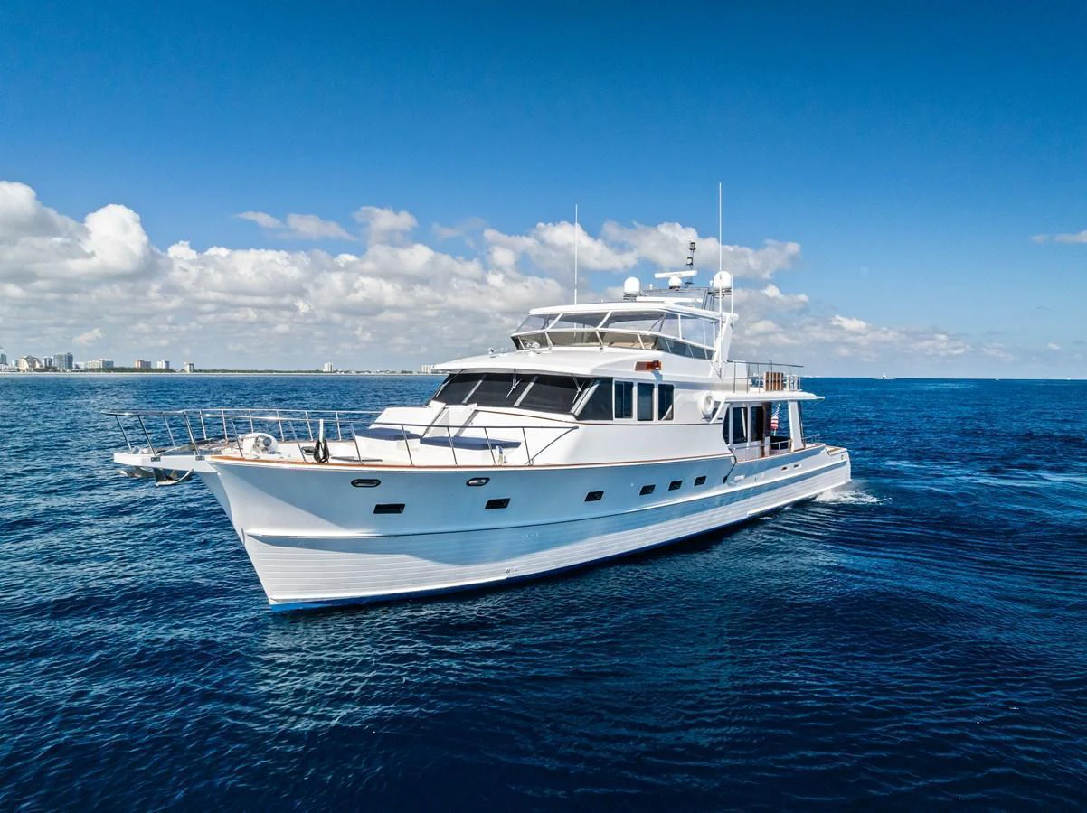 A stunning yacht cruising on open water under a clear blue sky. aboard EL LEGADO Yacht for Sale