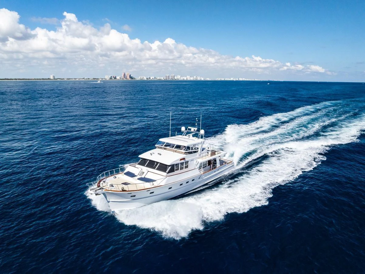 A luxurious yacht cruises through the open sea, leaving a trail of white waves behind. aboard EL LEGADO Yacht for Sale