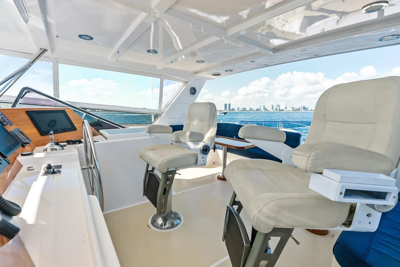 The helm area features plush seating and state-of-the-art navigation equipment with panoramic views of the sea. aboard EL LEGADO Yacht for Sale
