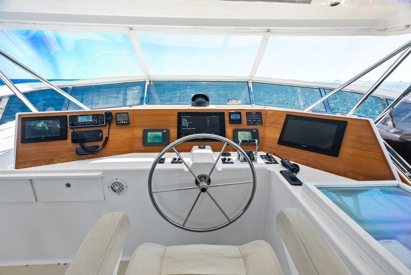 The helm station offers a commanding view with state-of-the-art navigation equipment and a sleek design. aboard EL LEGADO Yacht for Sale