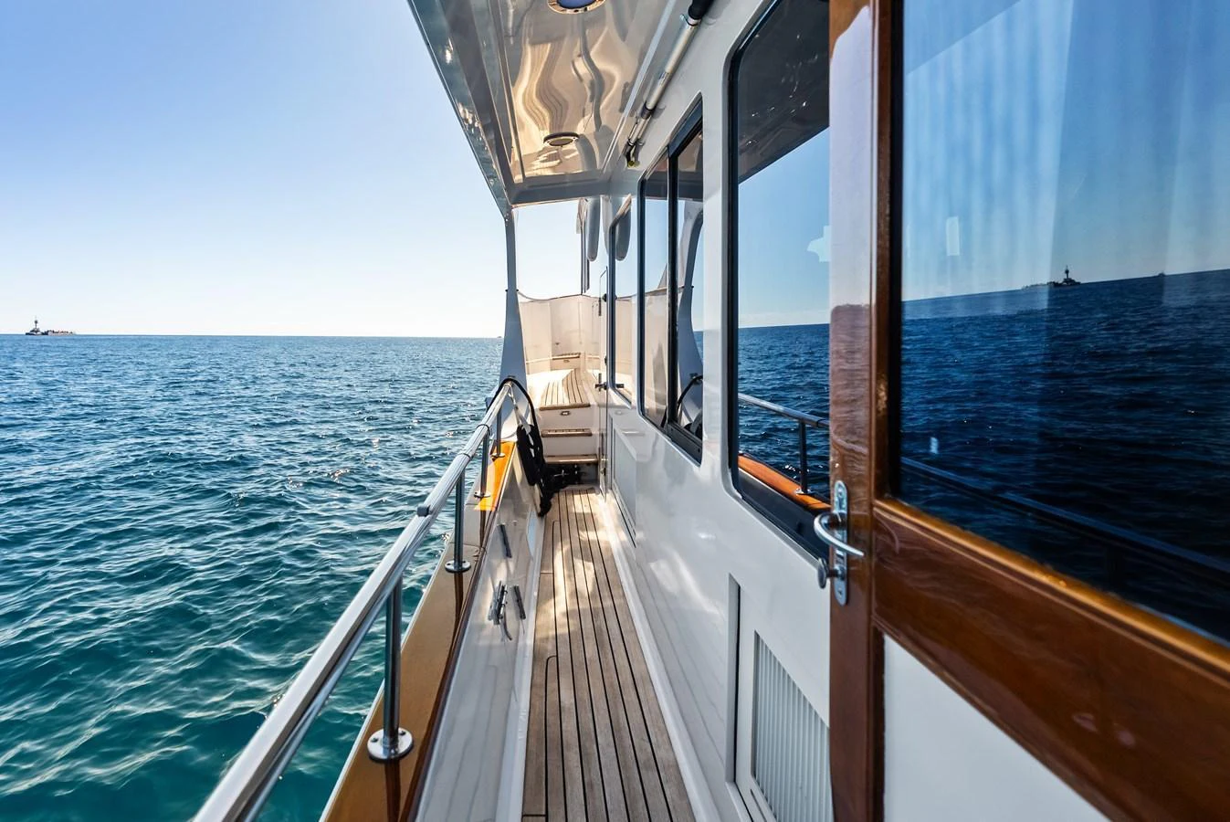 The side deck of the yacht offers a serene view of the open sea. aboard EL LEGADO Yacht for Sale