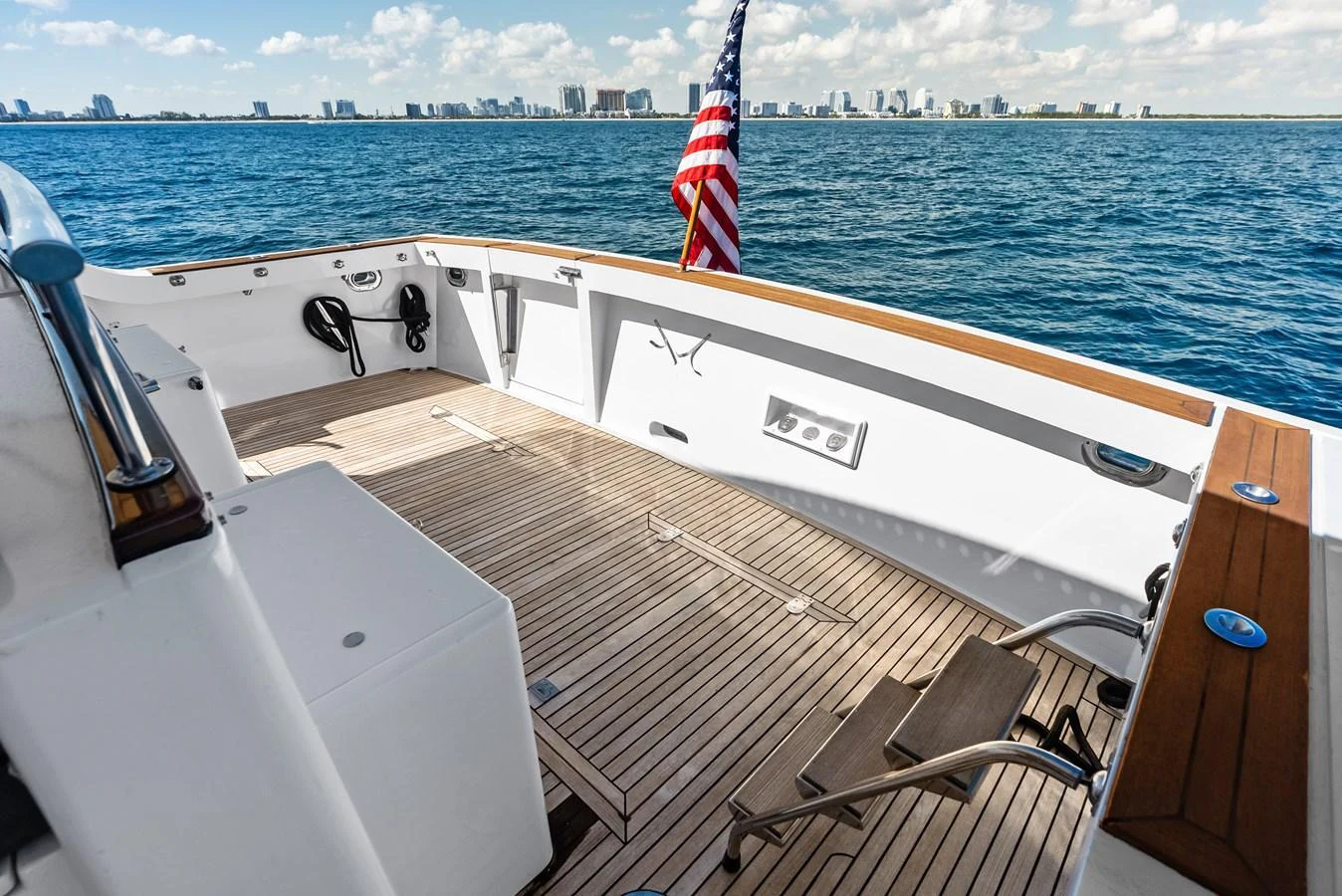 The aft deck offers a spacious and inviting area with a beautiful view of the water and city skyline. aboard EL LEGADO Yacht for Sale