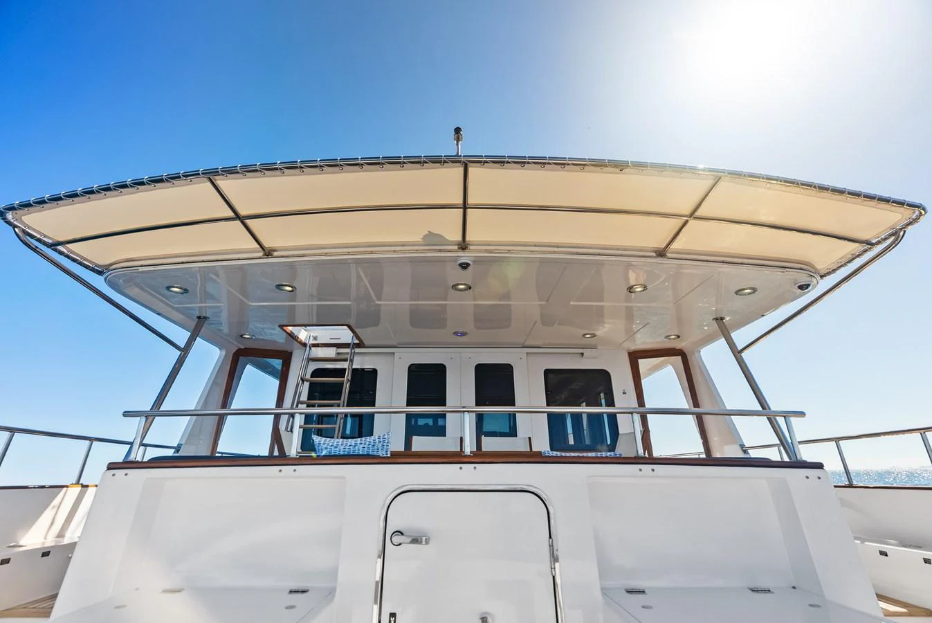 The yacht features a spacious and shaded aft deck area, perfect for relaxation and socializing. aboard EL LEGADO Yacht for Sale