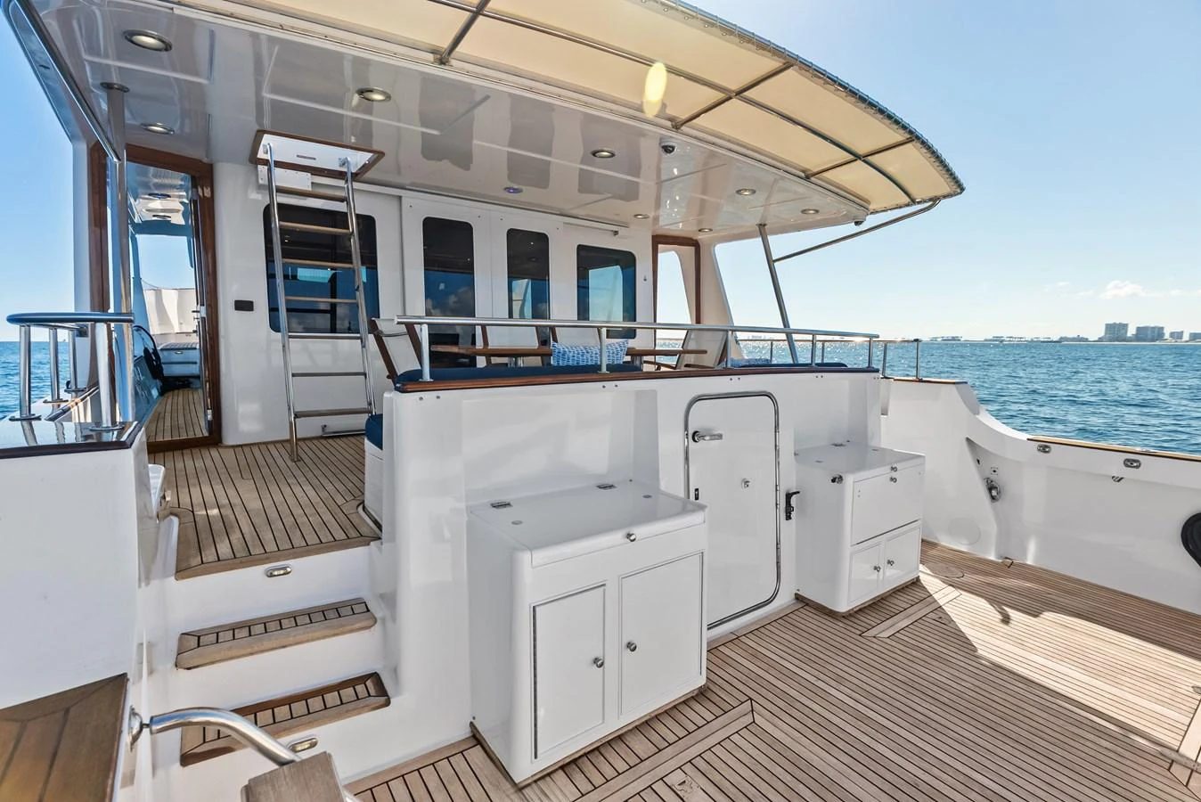 The spacious aft deck offers ample seating and storage with a beautiful view of the water. aboard EL LEGADO Yacht for Sale
