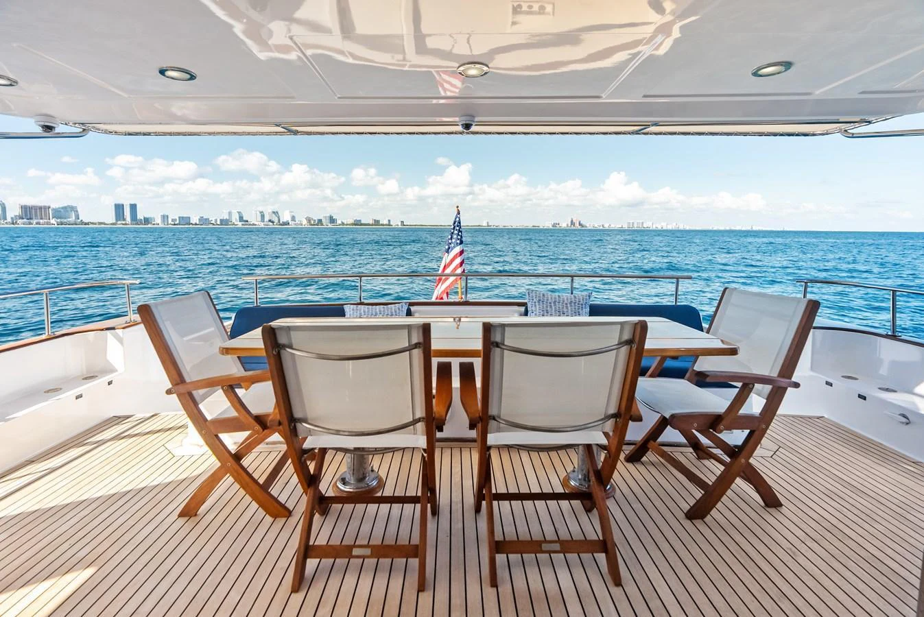 The aft deck offers a serene dining area with stunning ocean views. aboard EL LEGADO Yacht for Sale