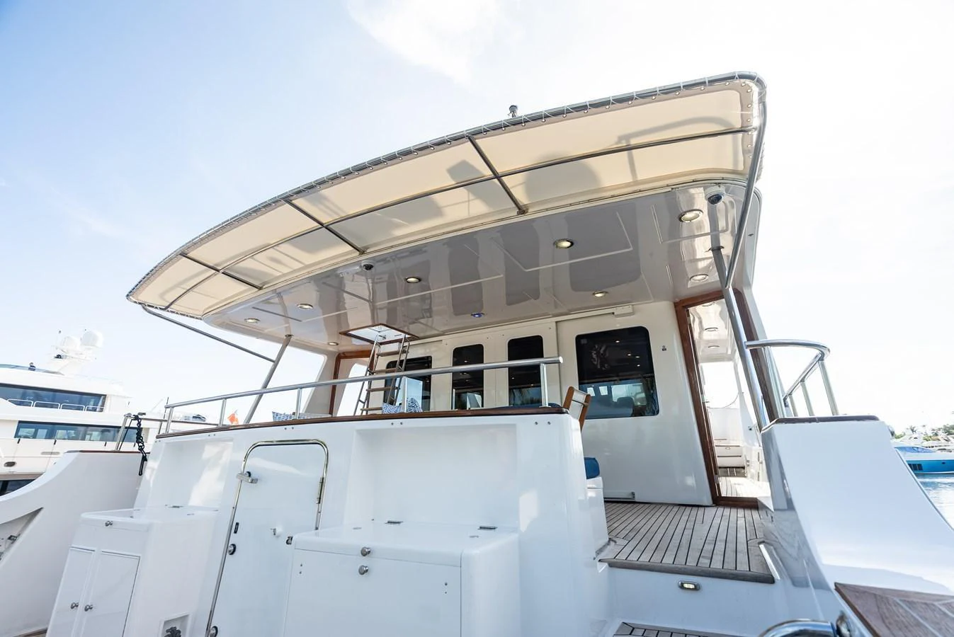 The yacht's aft deck features a spacious and inviting area with ample seating and a shaded canopy. aboard EL LEGADO Yacht for Sale