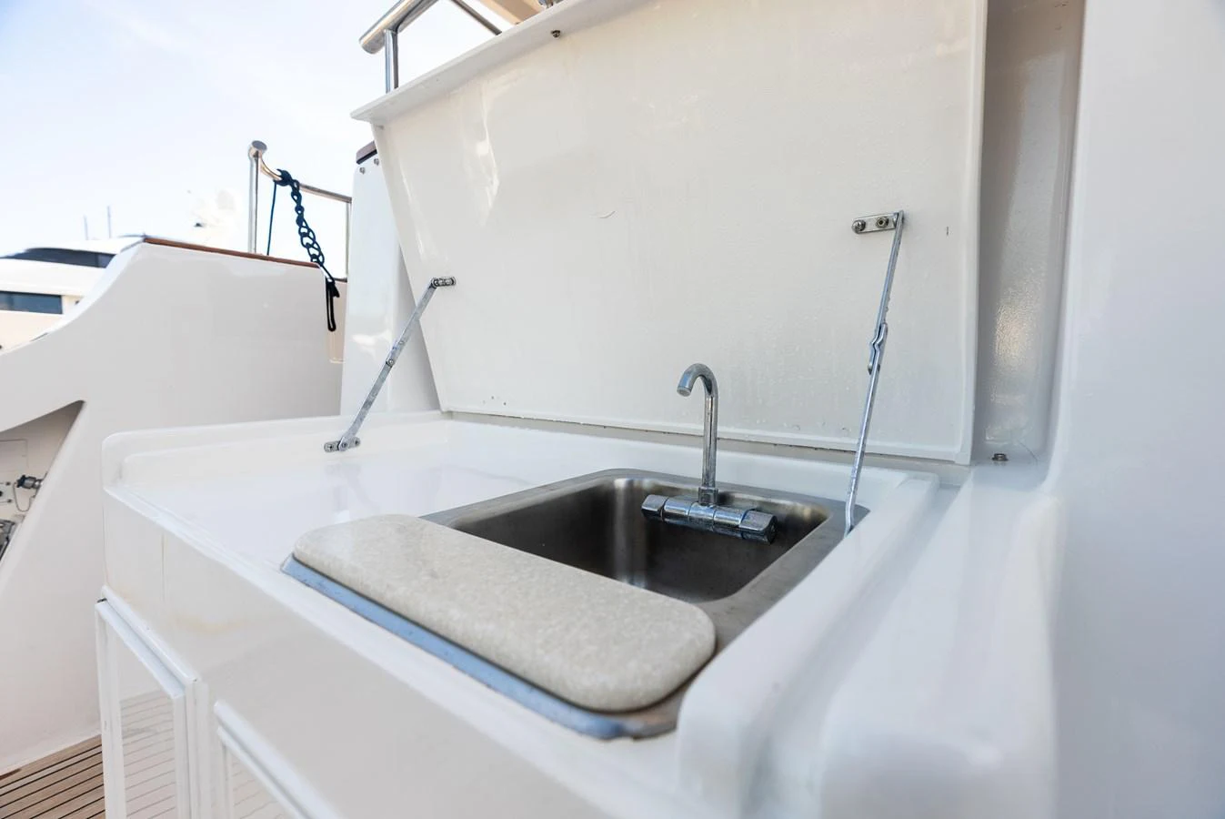 A close-up view of a yacht's sink area with a foldable cover. aboard EL LEGADO Yacht for Sale