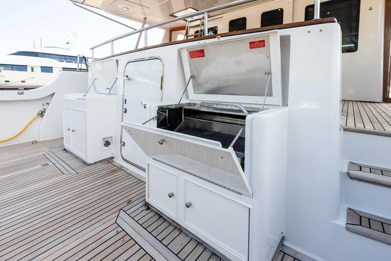 The aft deck features a built-in grill and ample storage for outdoor dining and entertaining. aboard EL LEGADO Yacht for Sale