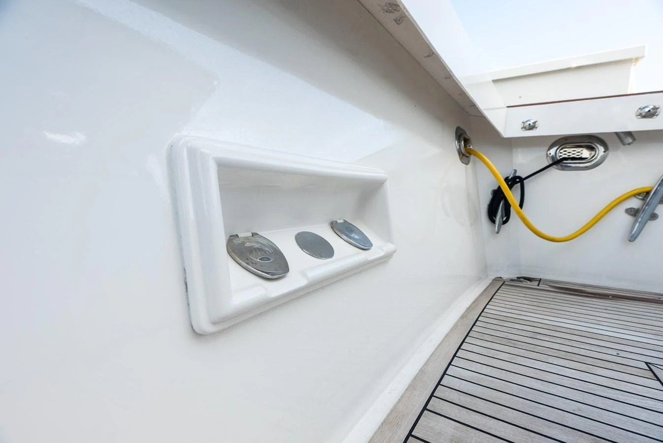 A close-up of the yacht's deck area showcasing utility connections and a clean, modern design. aboard EL LEGADO Yacht for Sale