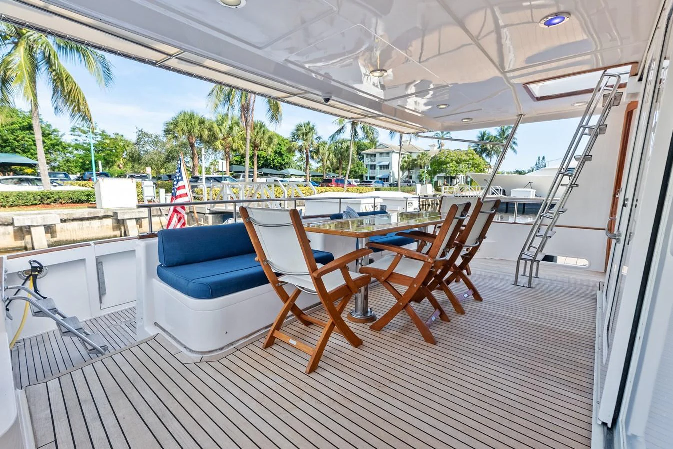 The aft deck features comfortable seating and a dining area, perfect for enjoying meals with a view. aboard EL LEGADO Yacht for Sale