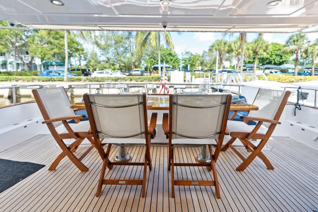 The aft deck features a stylish dining area with comfortable seating and a beautiful view. aboard EL LEGADO Yacht for Sale