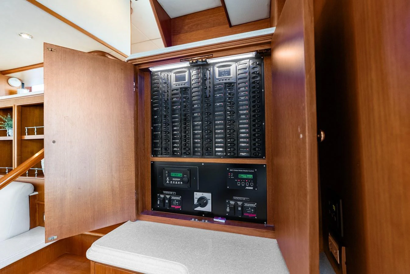 The image showcases the yacht's electrical control panel, neatly organized within a wooden cabinet. aboard EL LEGADO Yacht for Sale