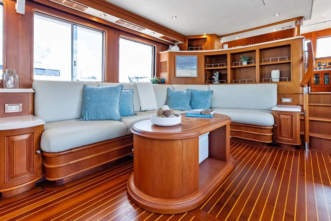 The salon features elegant wood finishes, plush seating, and ample natural light. aboard EL LEGADO Yacht for Sale