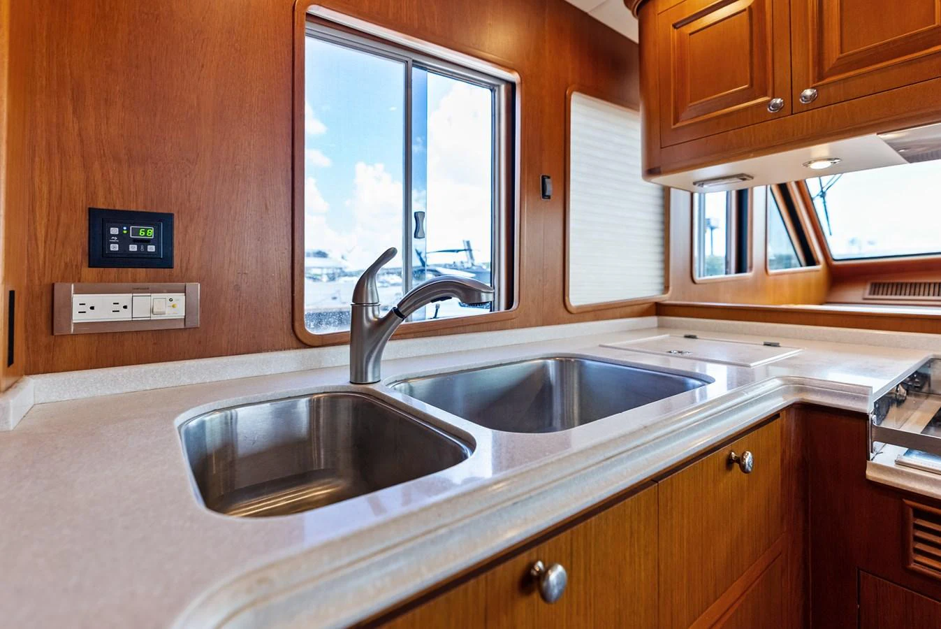 The galley features a sleek countertop with a double sink and ample natural light from the windows. aboard EL LEGADO Yacht for Sale