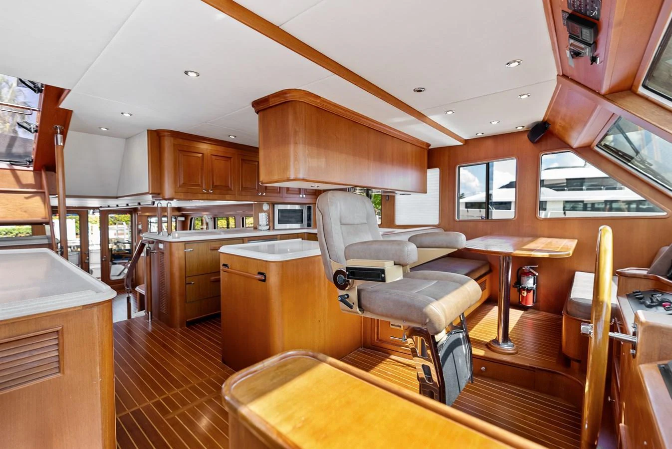 The helm area features comfortable seating and a well-equipped navigation station with a view of the surroundings. aboard EL LEGADO Yacht for Sale