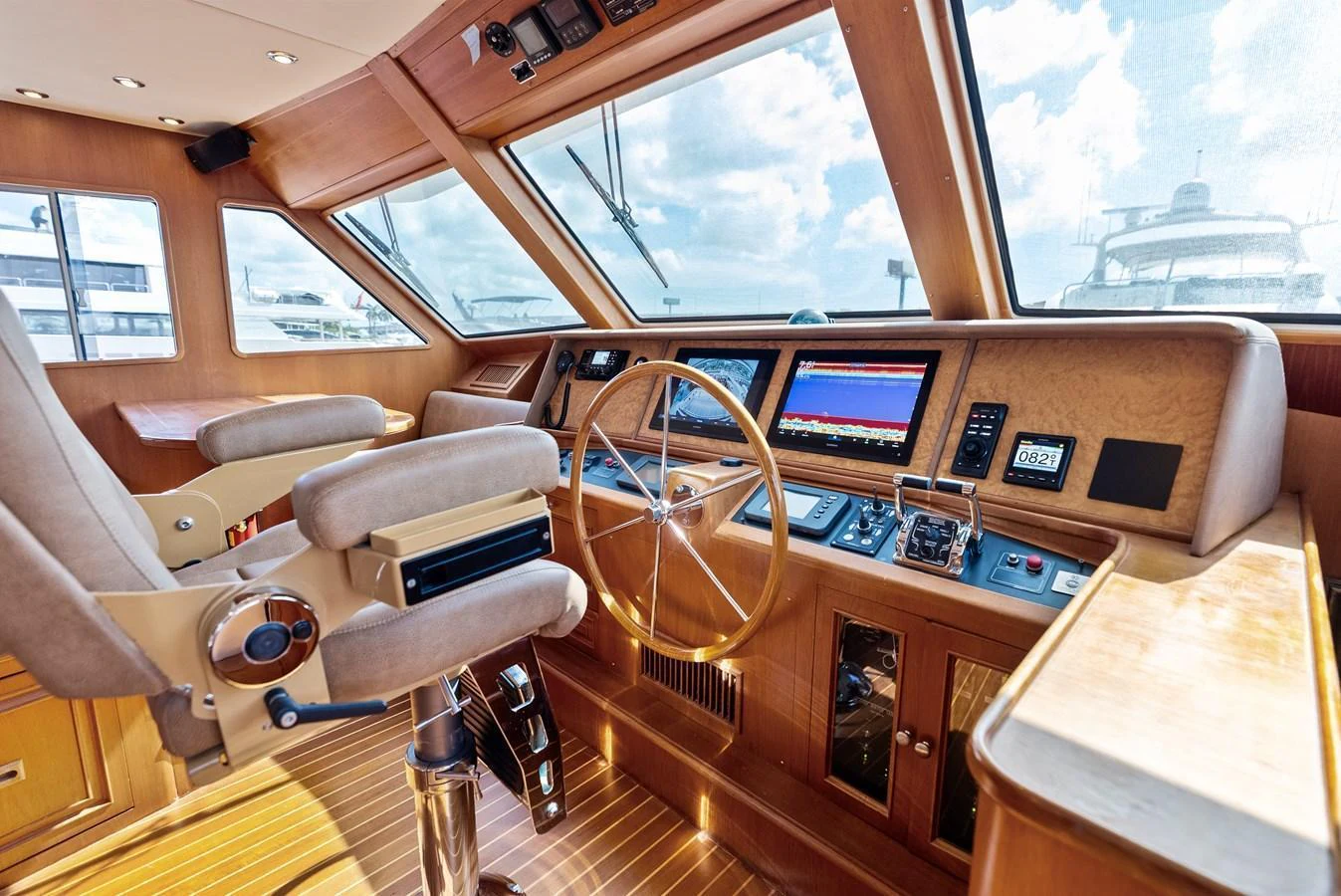 The helm station features a sophisticated control panel with plush seating and expansive windows offering excellent visibility. aboard EL LEGADO Yacht for Sale