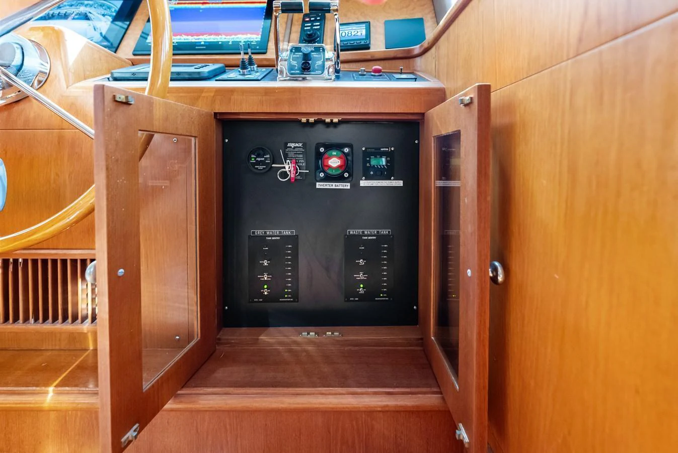 The image showcases the yacht's electrical control panel, neatly housed within a wooden cabinet. aboard EL LEGADO Yacht for Sale