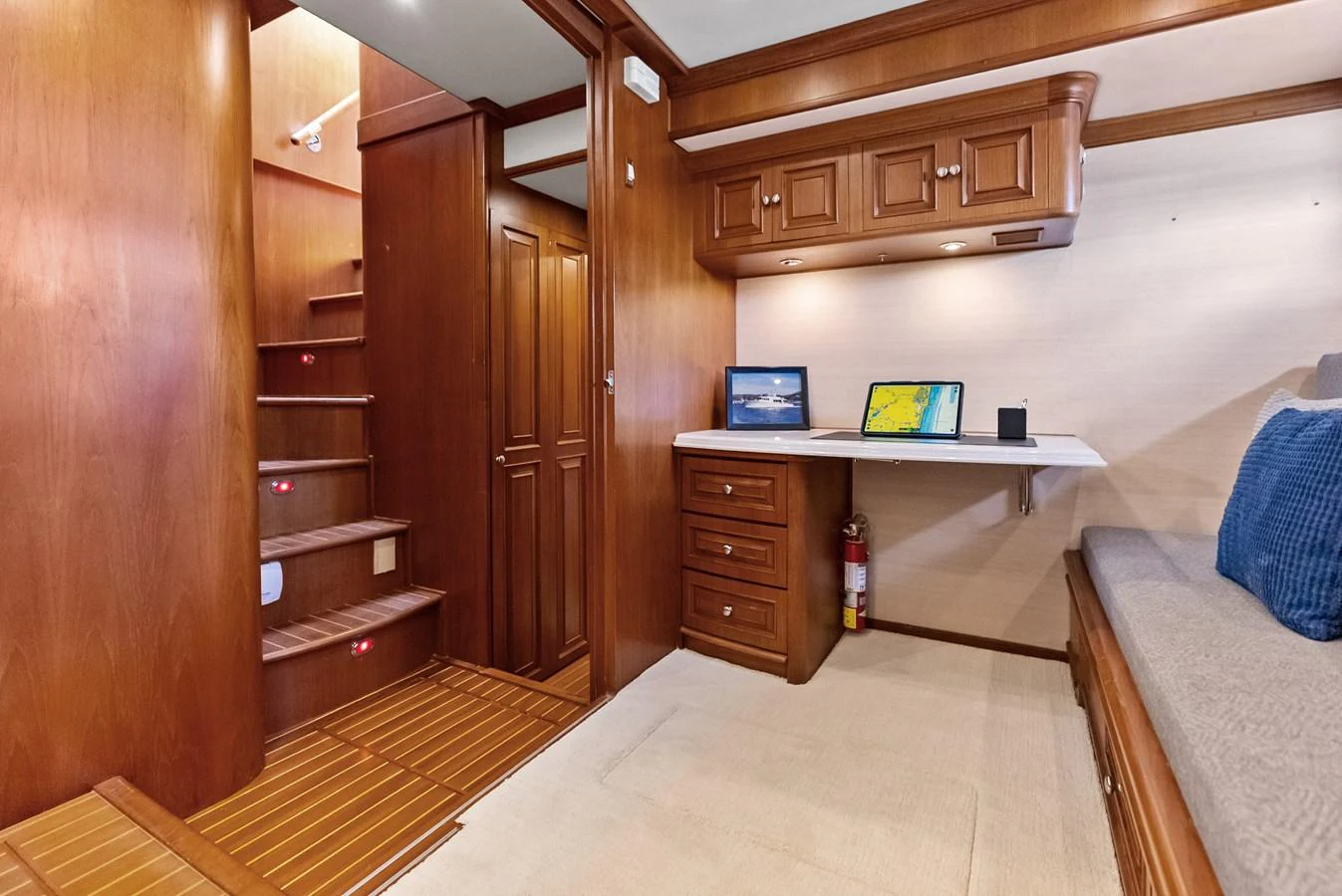 The yacht's office area features a wooden desk with modern technology and comfortable seating. aboard EL LEGADO Yacht for Sale