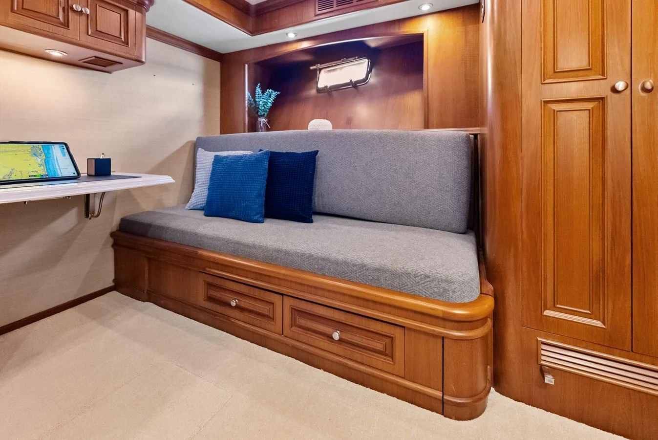 The cabin features a cozy seating area with wooden cabinetry and soft lighting. aboard EL LEGADO Yacht for Sale