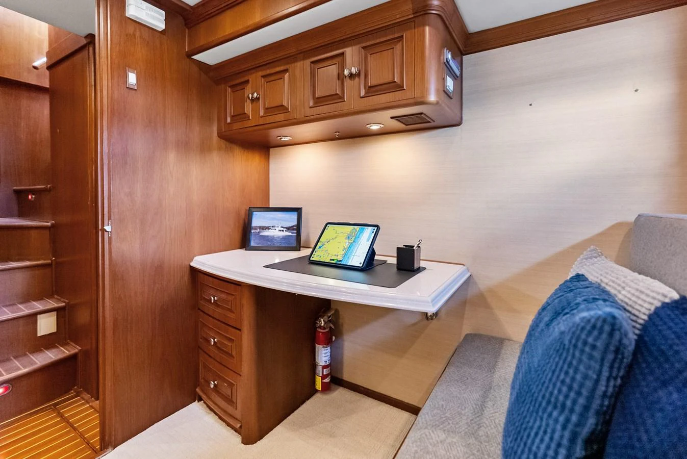 A cozy office area with a fold-down desk and comfortable seating, perfect for work or navigation planning. aboard EL LEGADO Yacht for Sale