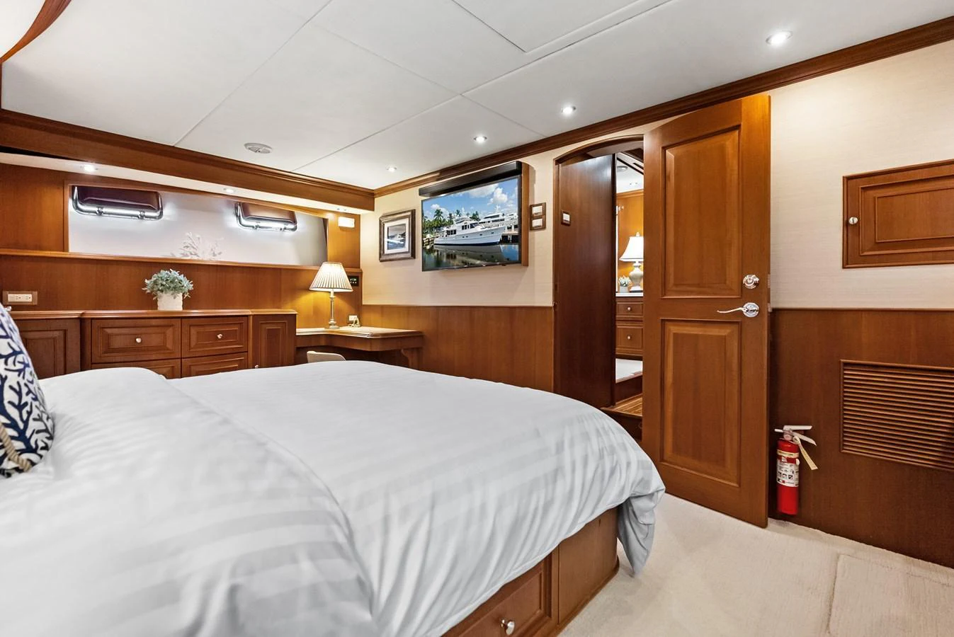 A luxurious stateroom featuring a comfortable bed, wooden cabinetry, and modern lighting. aboard EL LEGADO Yacht for Sale